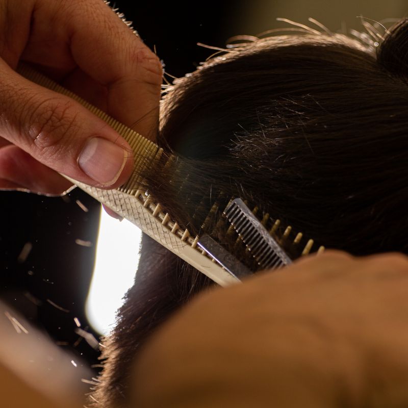 Stylist trimming hair